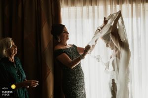 mother-of-the-bride-and-gransmother-assist-bride-with-her-veil-at-the-Westin-Riverwalk-on-her-wedding-day-in-San-Antonio-Texas-photo-2329376
