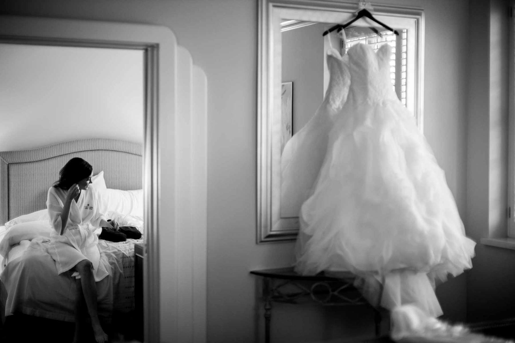 Bride-on-wedding-day-adds-earrings-at-Hotel-Galvez-in-Galveston-Texas-framed-in-a-doorway