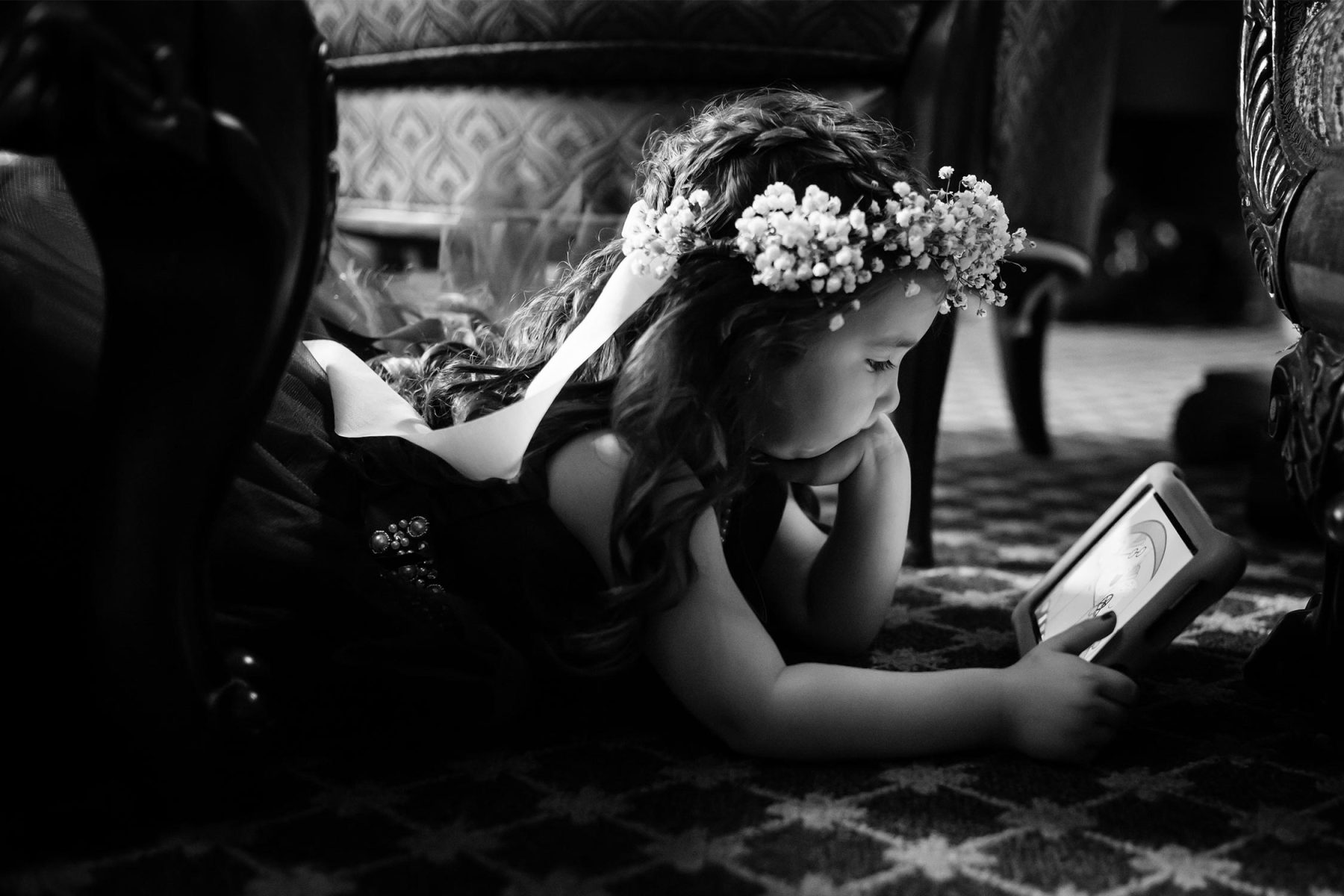 Flower-girl-during-getting-ready-at-the-historic-Menger-Hotel-passes-the-time-on-a-Apple-iPad-L1006380