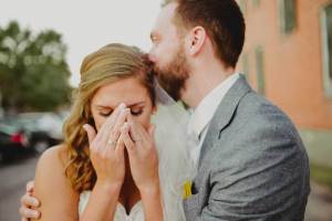 Emotional-image-showing-bride-and-groom-moments-after-getting-married-and-calling-her-grandfather-who-could-not-attend-wedding.-Galveston-Texas-photographed-with-a-Leica-M240