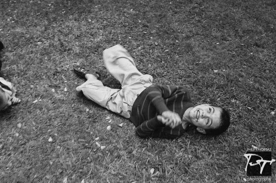 Philip Thomas Photography - Boy rolling down hill