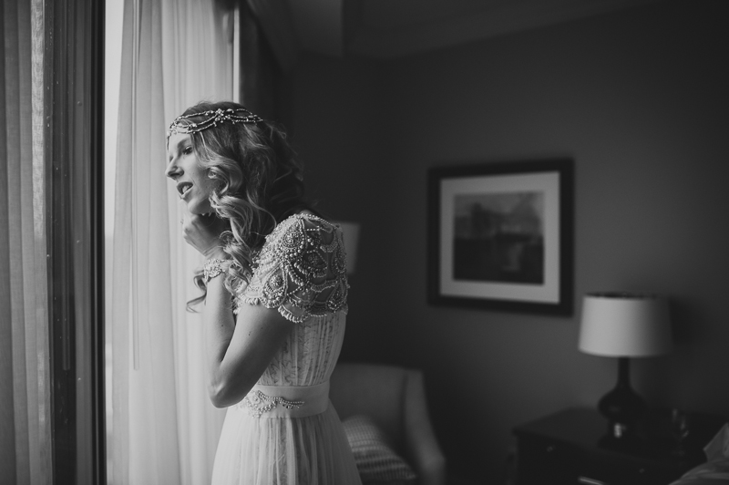 Bride putting earrings on