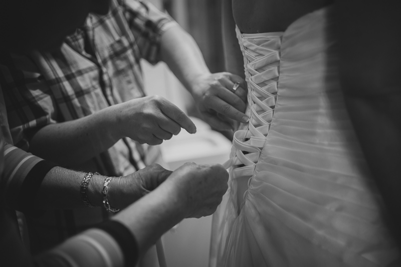 Tying the back of the brides dress