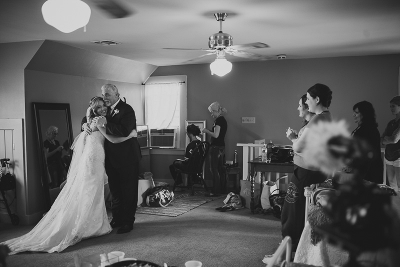 father of the bride embraces daughter on first look