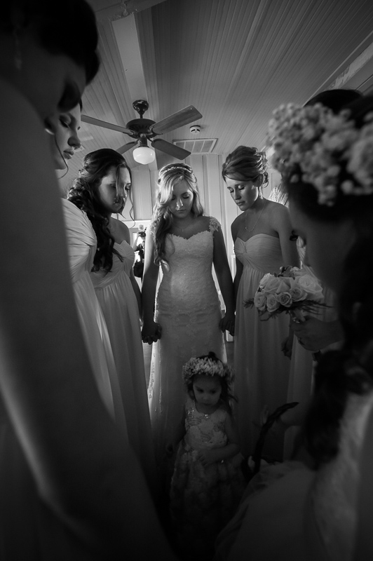 bride and bridesmaid hold prayer before ceremony