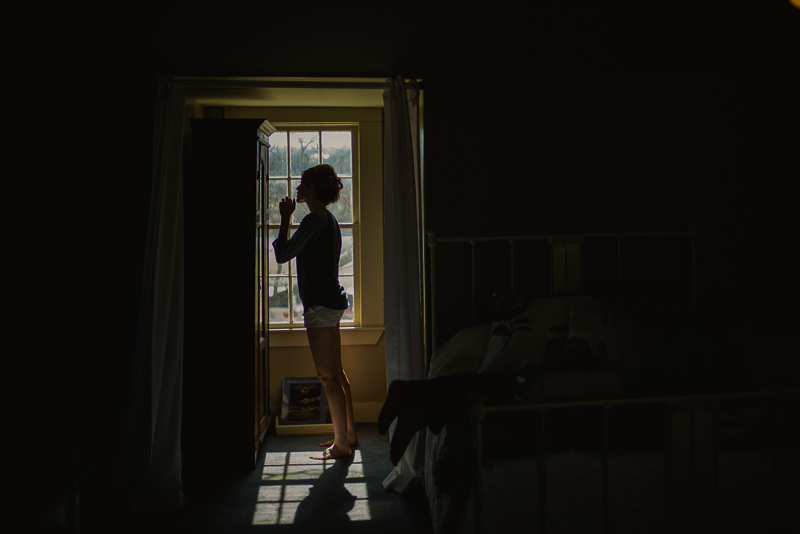 Bridesmaid gets ready in window