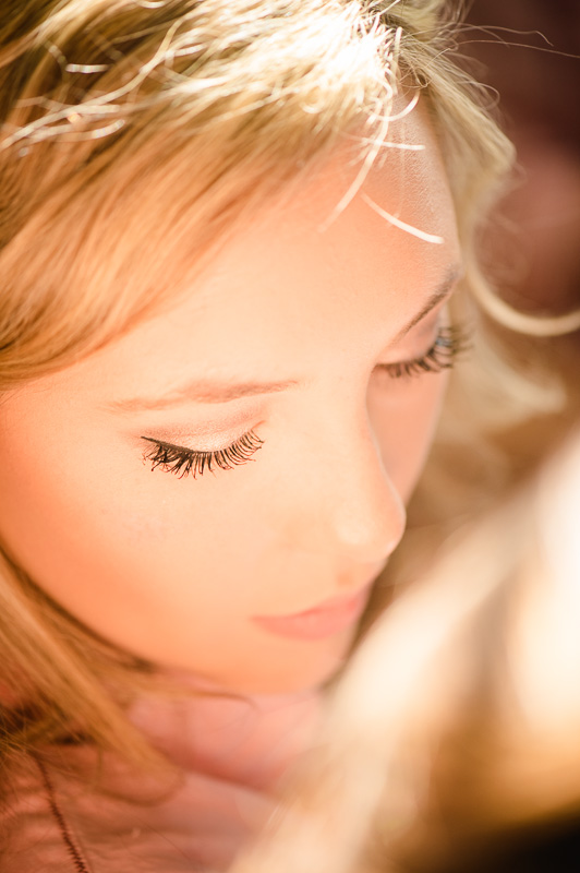 Brides applies makeup looking down