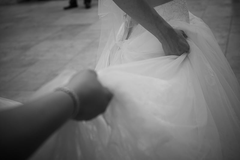 Holding the brides dress