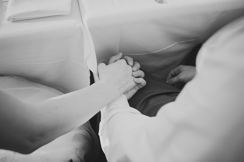 Couple holding hands during wedding reception at Paesanos, San Antonio