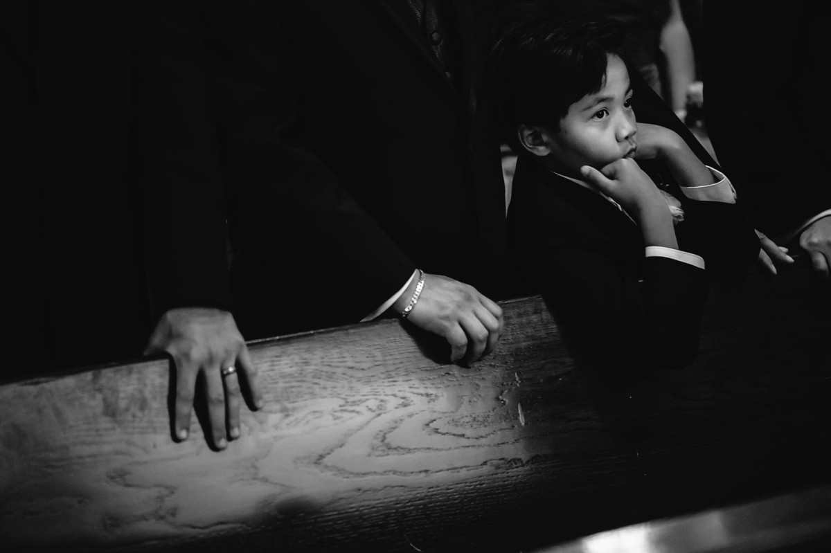 A boy rests on his hands and appears bored during a wedding ceremony in san antonio texas