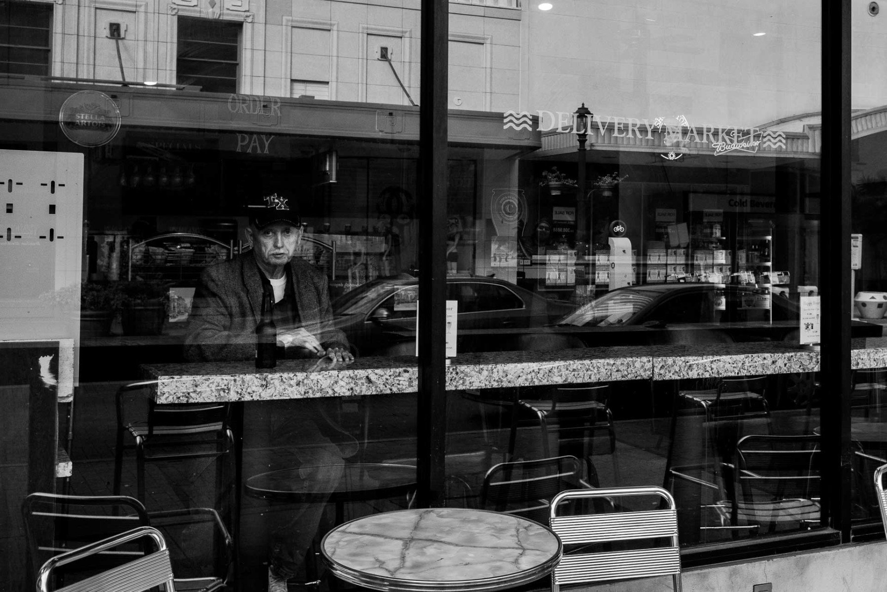 A man stares out of a window at a downtown bar in San Antonio Texas Leica Street Photography Philip Thomas