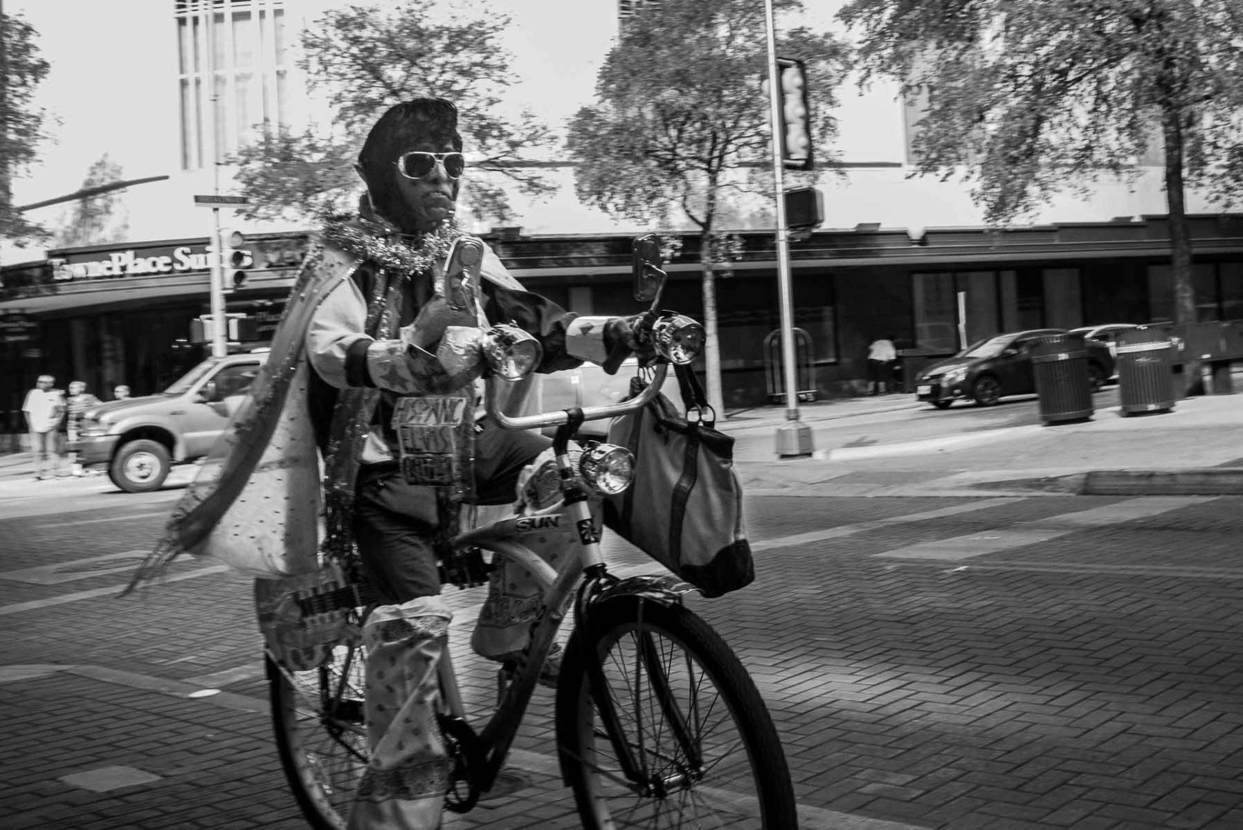 An Elvis impersonator rides through downtown on his bike Leica Street Photography Philip Thomas