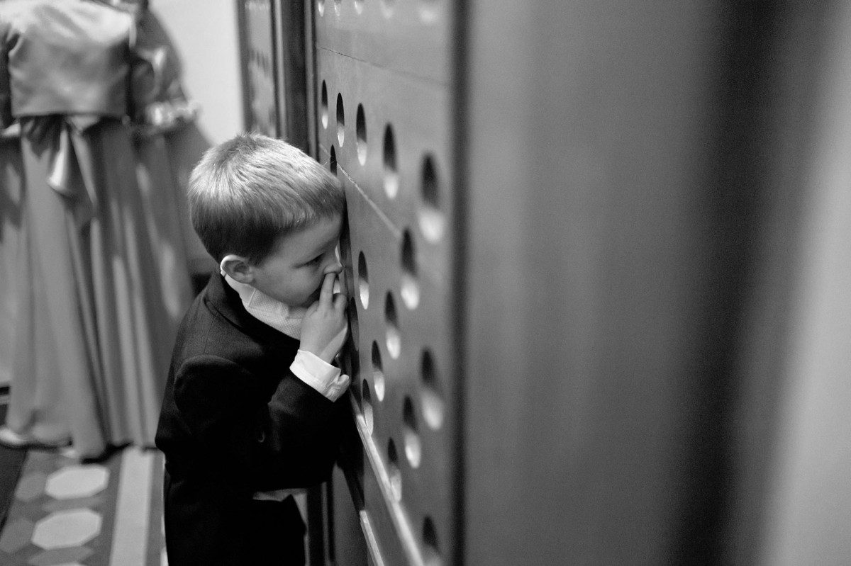 Boy picking nose and peeking