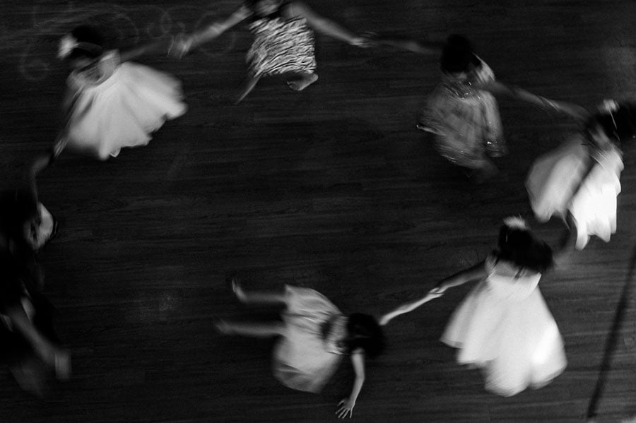 San Antonio wedding photography Philip Thomas captures an ethereal moment as flower girls holding hands in a circle captured with a slow shutter Leica M