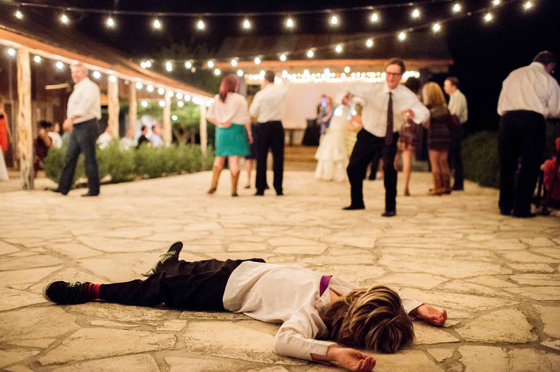 Little boy pretends to be asleep at Welfare Cafe Boerne - Philip Thomas Photography