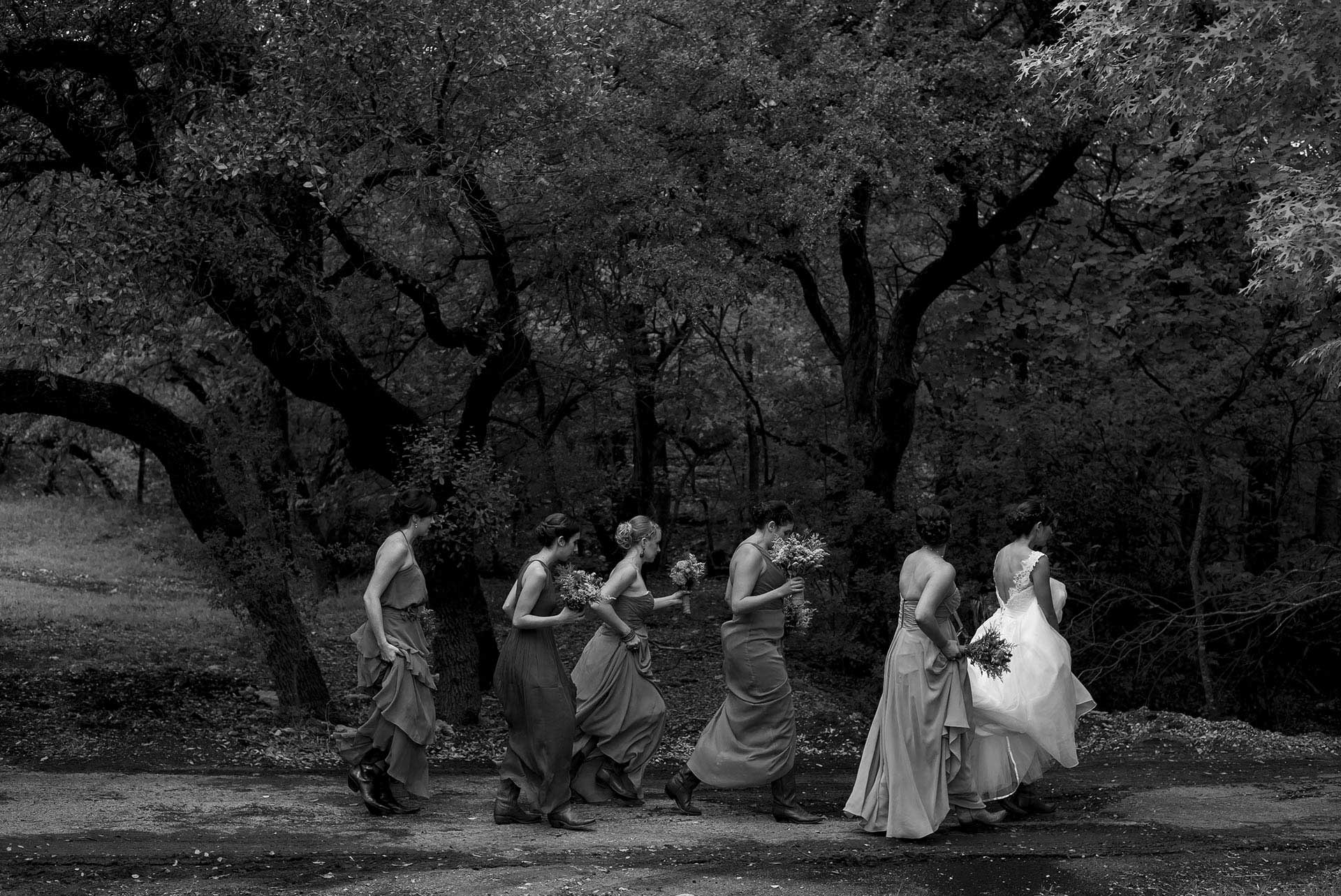 Bridesmaids and bride walk to ceremony