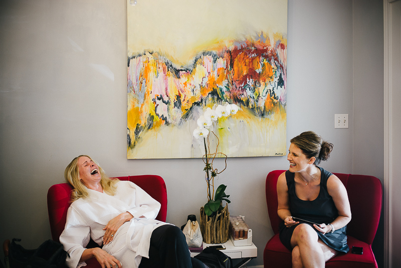 Bride shares a joke with bridesmaids at The Houstonian, Houston, Texas Wedding photographer Philip Thomas