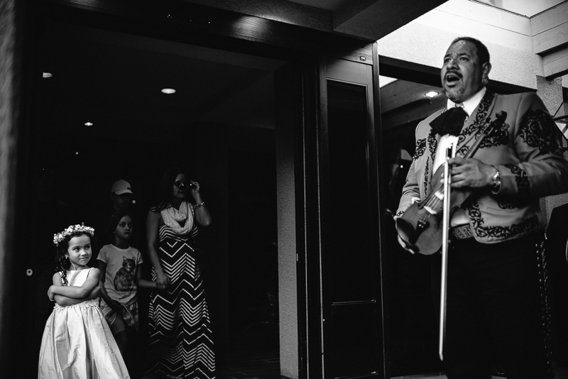 Girl watches a mariachi sing