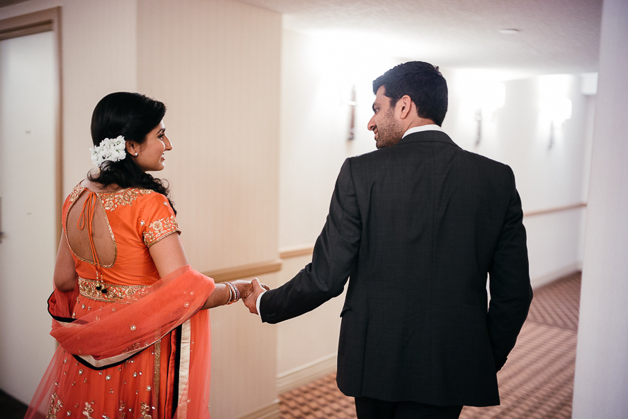 Bride and groom holding hans pre cocktail party Sheraton Mahwah Hotel New Jersey