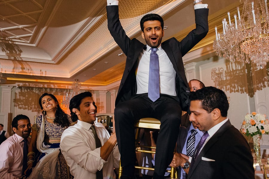 Bride and groom lifted high in air - South Asian Wedding