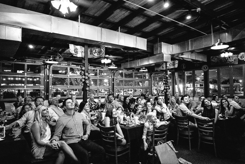 Viewers during a wedding rehearsal dinner slideshow