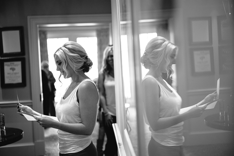 Bride reads a love letter from groom in reflection