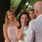 Bride wipes tear from face during ceremony Hoffman Haus