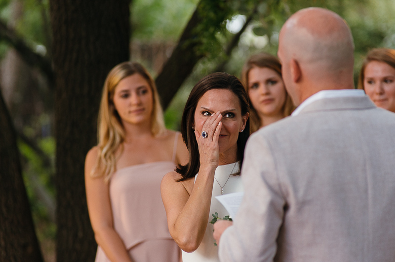 Bride wipes tear from face during ceremony Hoffman Haus