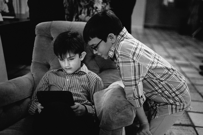 Boys playing games on devices during wedding reception Hoffman Haus