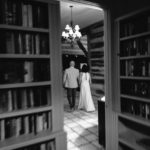 Bride and groom walk from the library during their wedding reception at Hoffman Haus