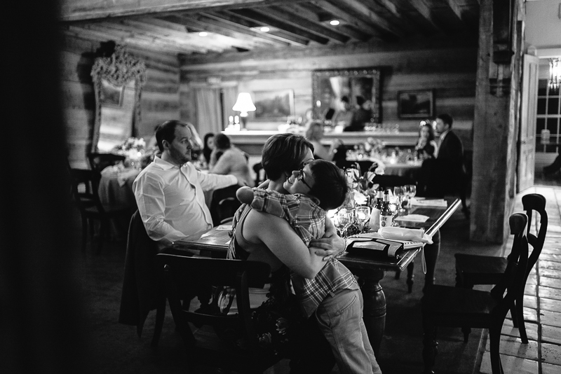 Little boy embraces his mother during wedding reception at Hoffman Haus