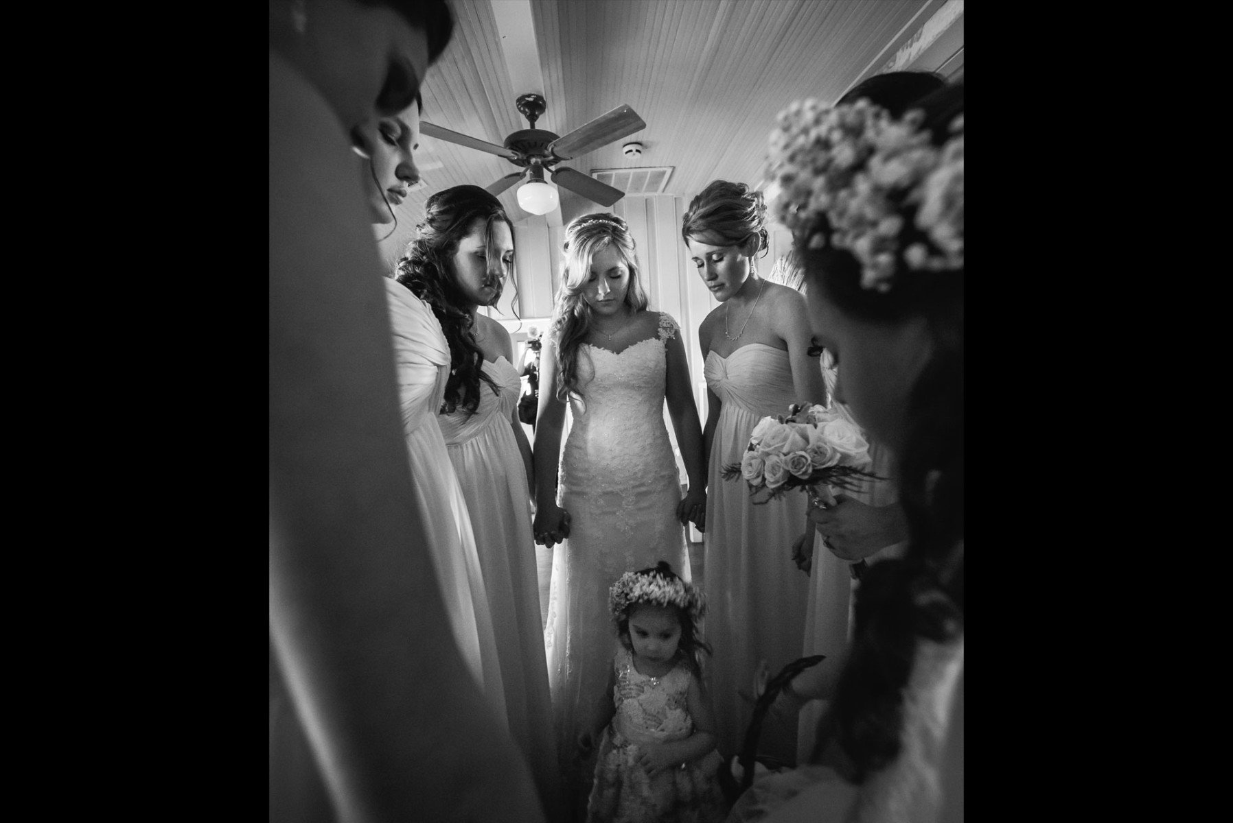 Bridesmaids share a prayer at Don Strange Ranch moments before walking down the aisle. San Antonio Wedding Photographers
