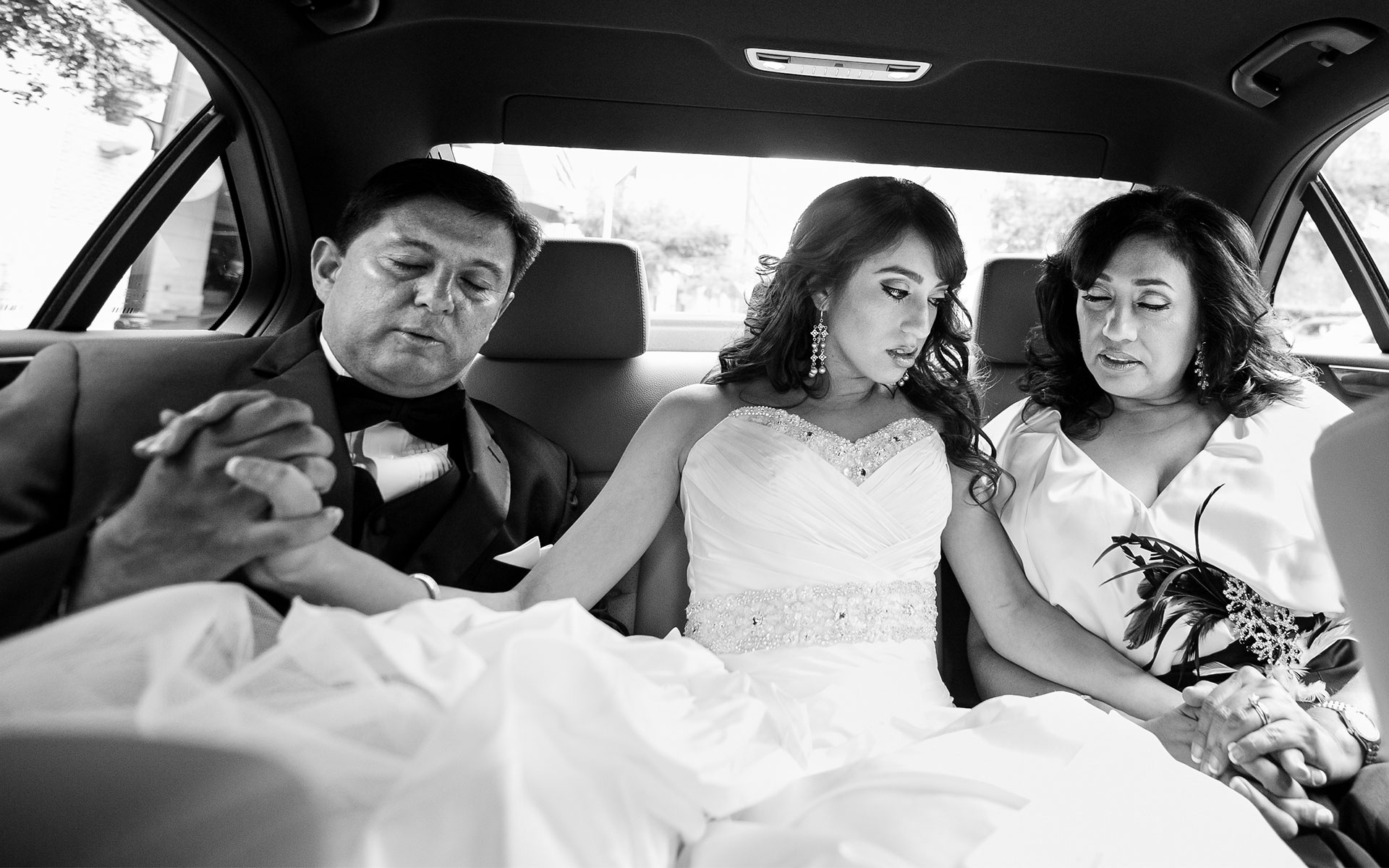 Bride with mother and father in limo