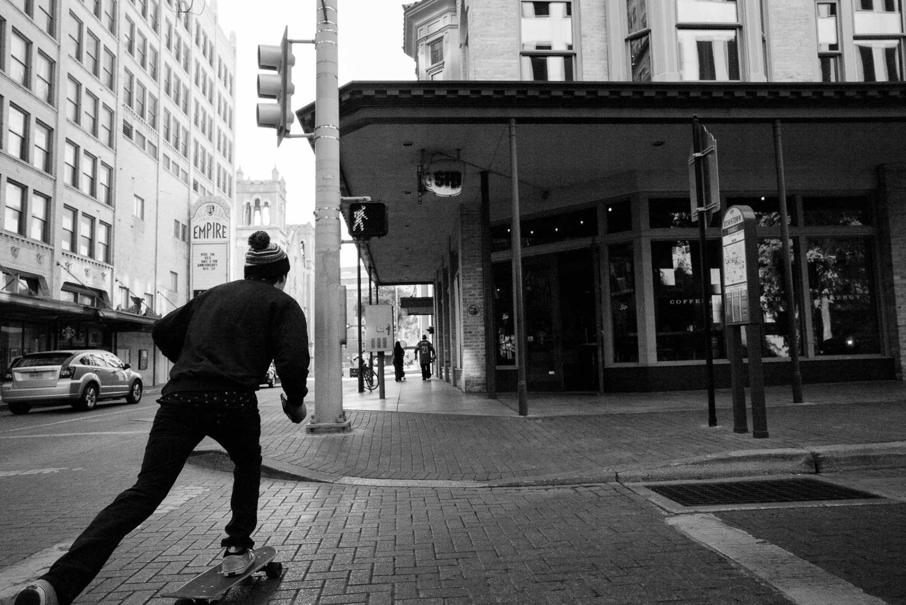A skateboarder passes by on Houston Street San Antonio Leica Street Photography by PHilip Thomas