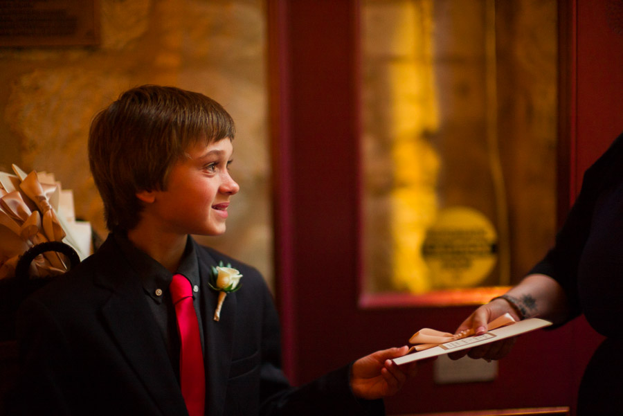 Boy handing out programs at La Villita