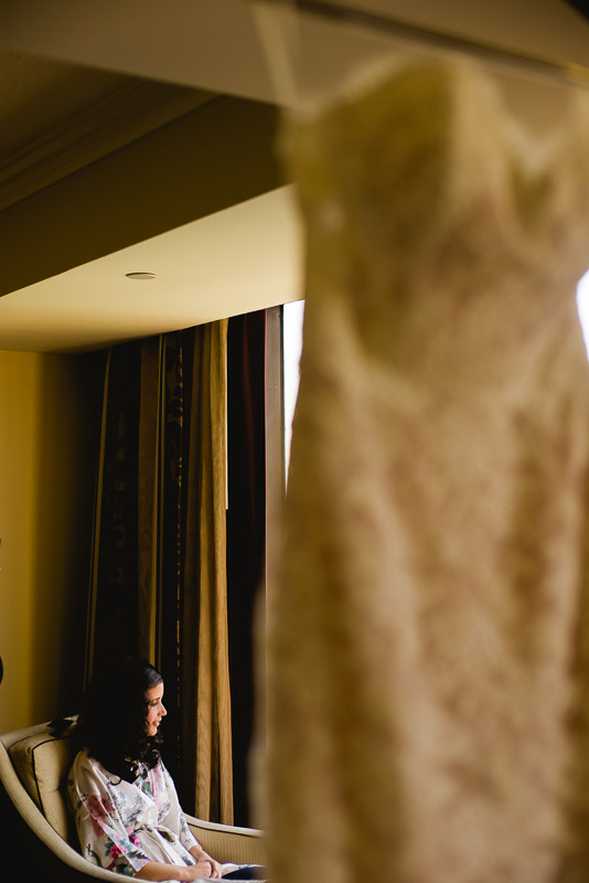 Bride getting ready with bridal gown in foreground Omni Houston Hotel