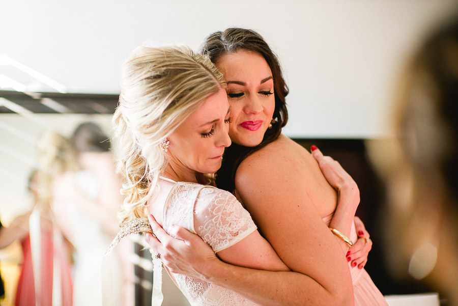 Bride and bridesmaid hug