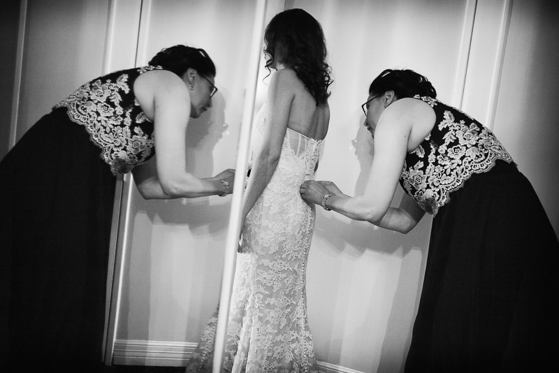 Mother helps bride et ready in mirror at Omni Houston Hotel