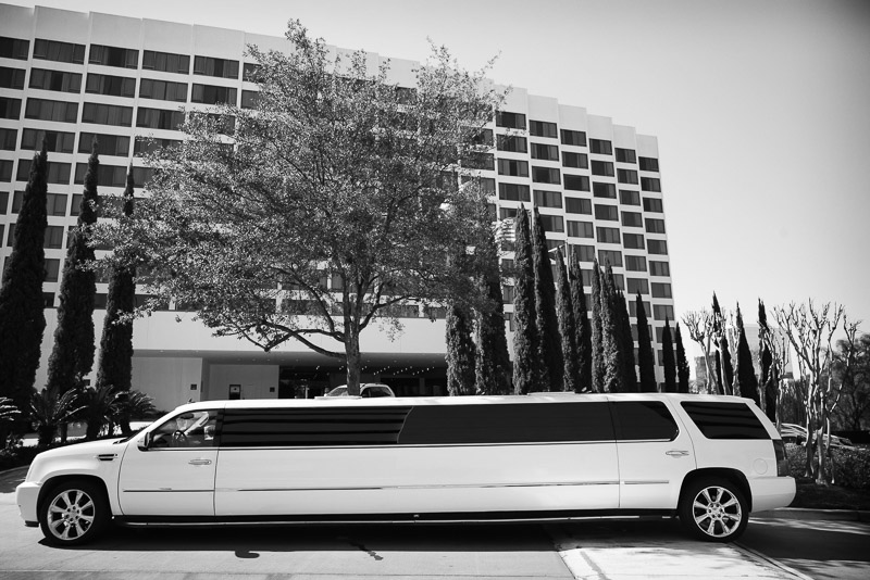 White limo pulls up outside Omni Houston Hotel for wedding