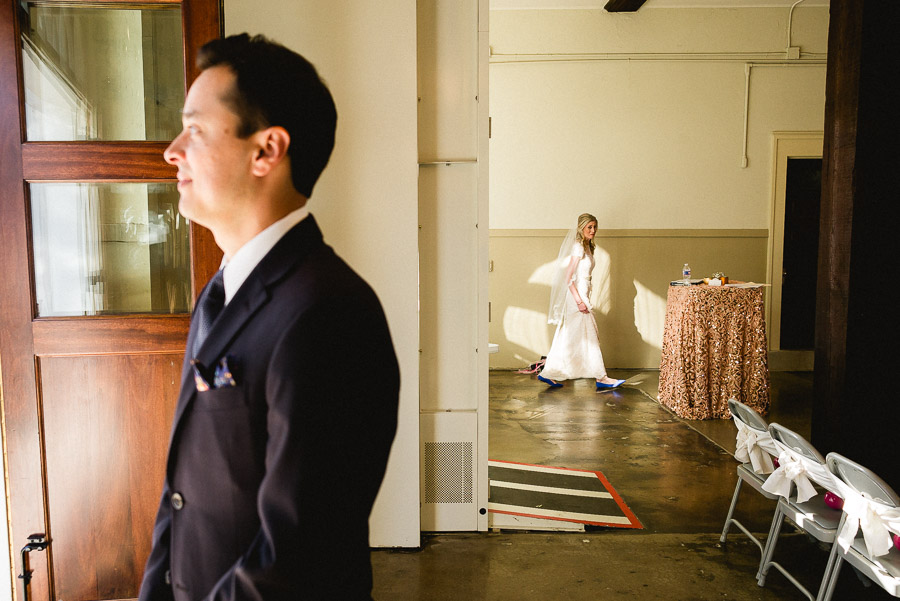 First look as bride glances at groom at Houston Heights Fire Station