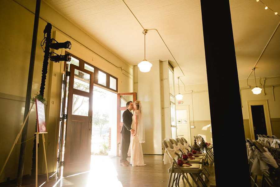 Couple hold hand as bride glances at groom at Houston Heights Fire Station