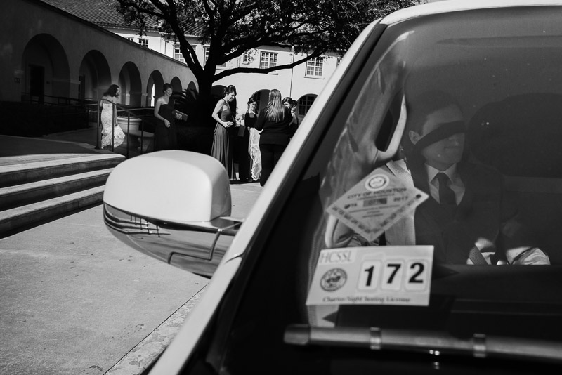 To avoid seeing the bride, groom wears at tie over his eyes while waiting in limo as bride enters St. Anne's church