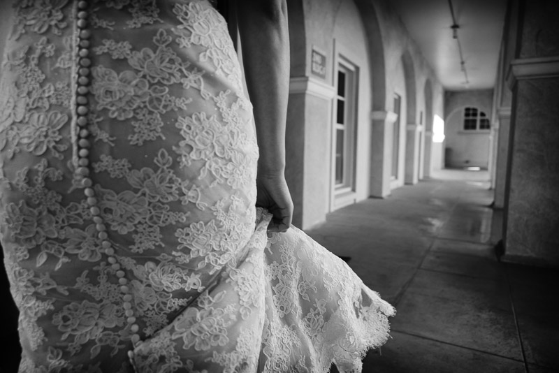 Bride clutching her dress arriving at St. Anne Catholic Church, 2140 Westheimer Rd, Houston