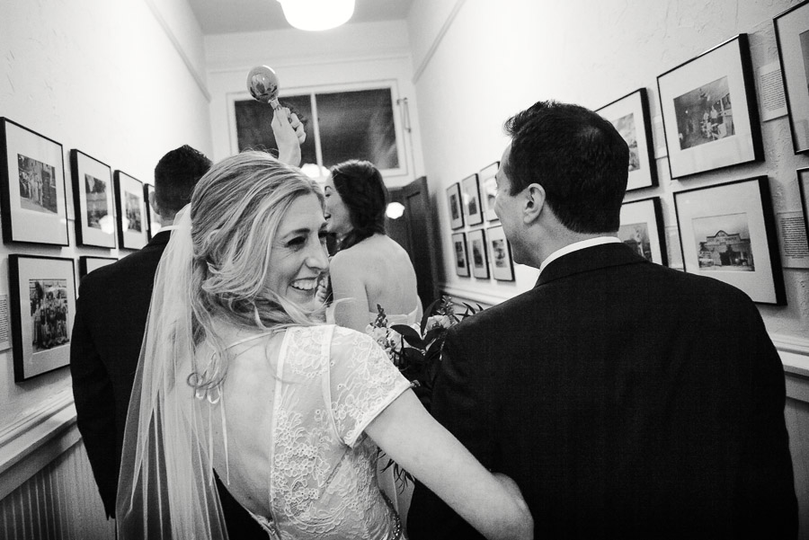 Bride looks back over her shoulder at wedding reception Houston Heights Fire Station