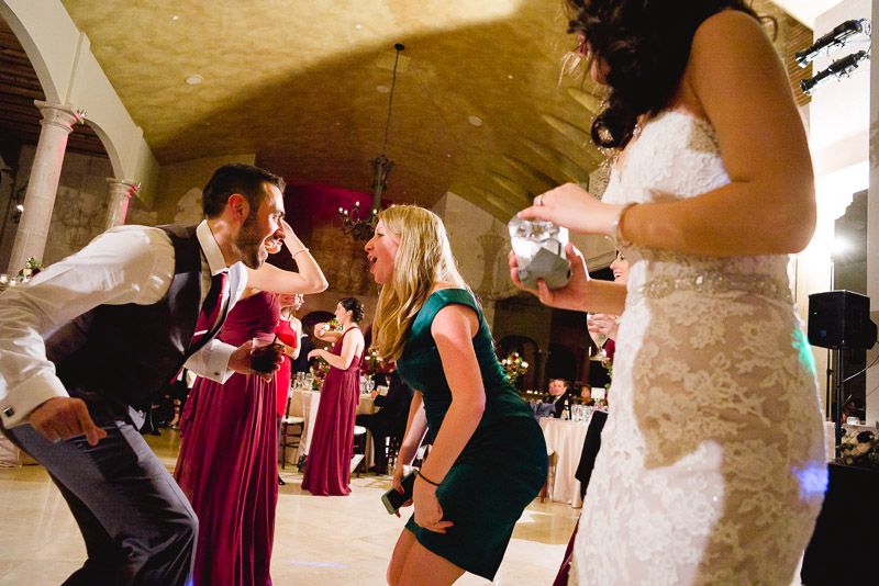 Couple dancing with bride foreground The Bell Tower on 34th, Houston.