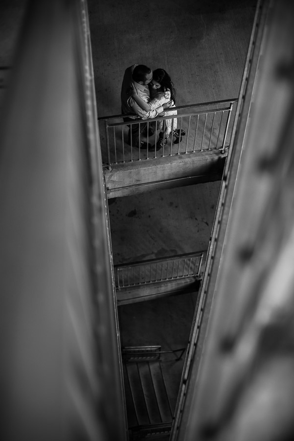 Engagement shoot in parking lot looking down with triangular structure concept