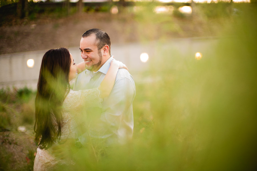 Among wispy grass at Pearl Brewery engagement shoot