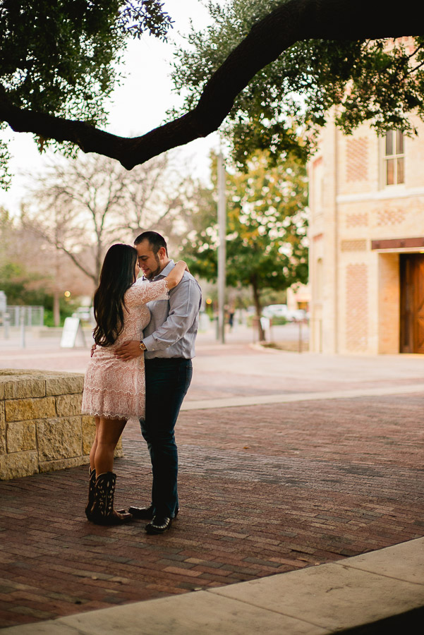 Cute shot of engaged couple outside Pearl Stables