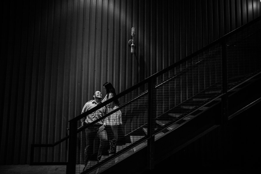 On metal staircase Shadow and lines at Pearl Brewery Culinary Institute building with engaged couple