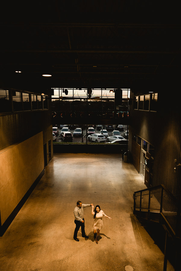 Wide angle couple engaged San Antonio Pearl Brewery peak moment dancing